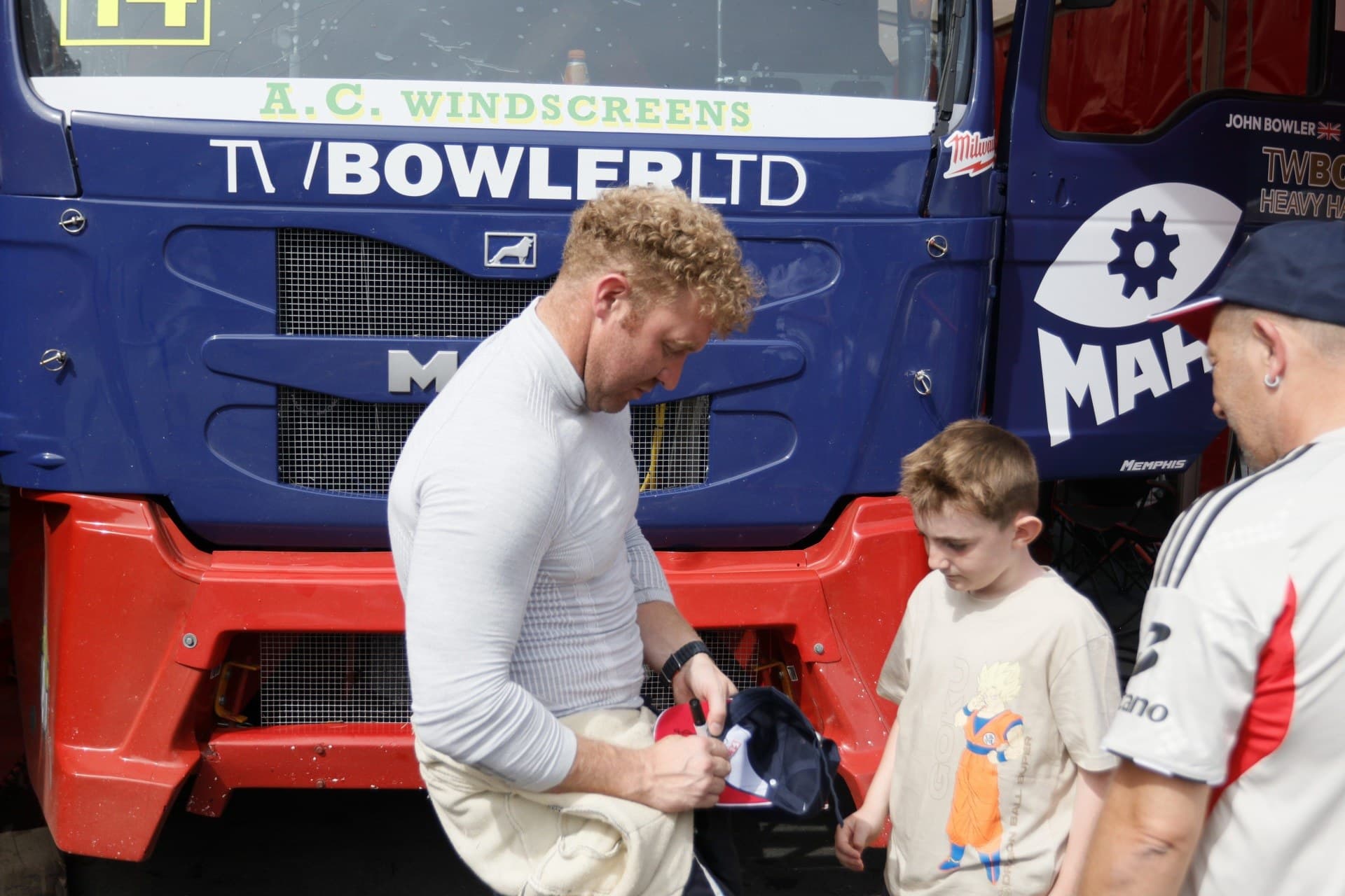 John Bowler signing a cap for a young fan in front of Diana