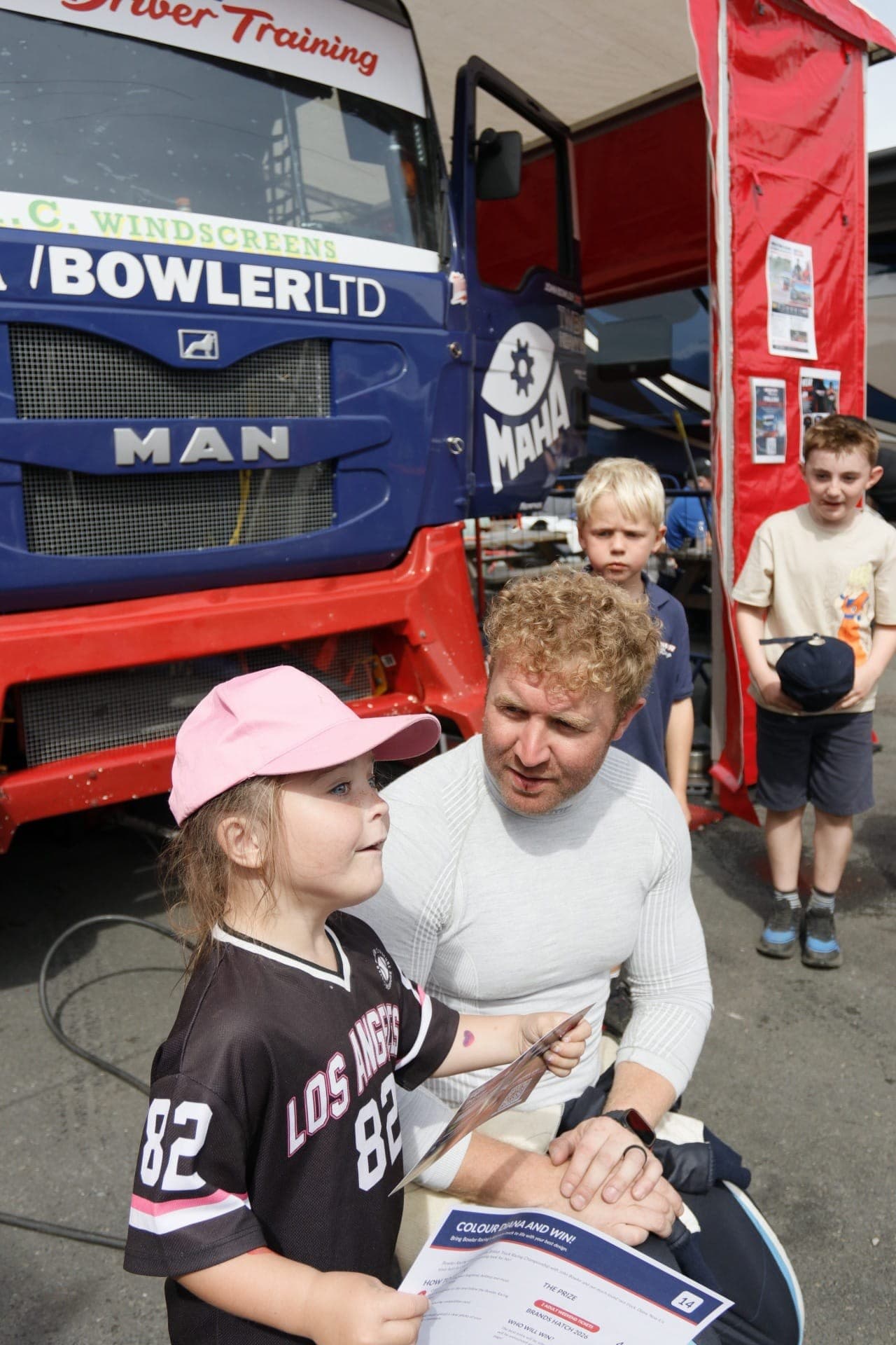 John Bowler talking with a young supporter beside Diana in the paddock