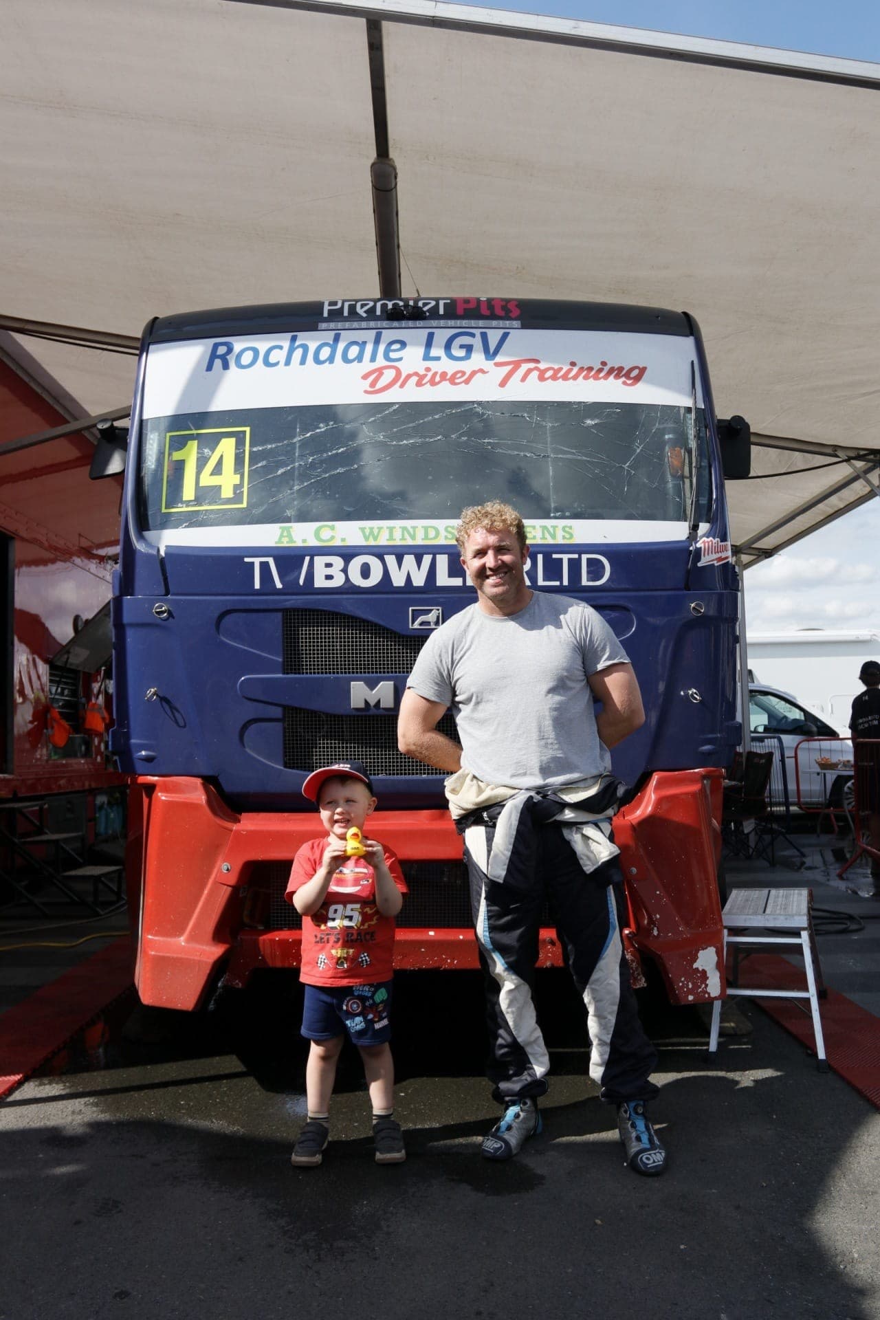A young Bowler Racing fan posing with John Bowler in front of Diana