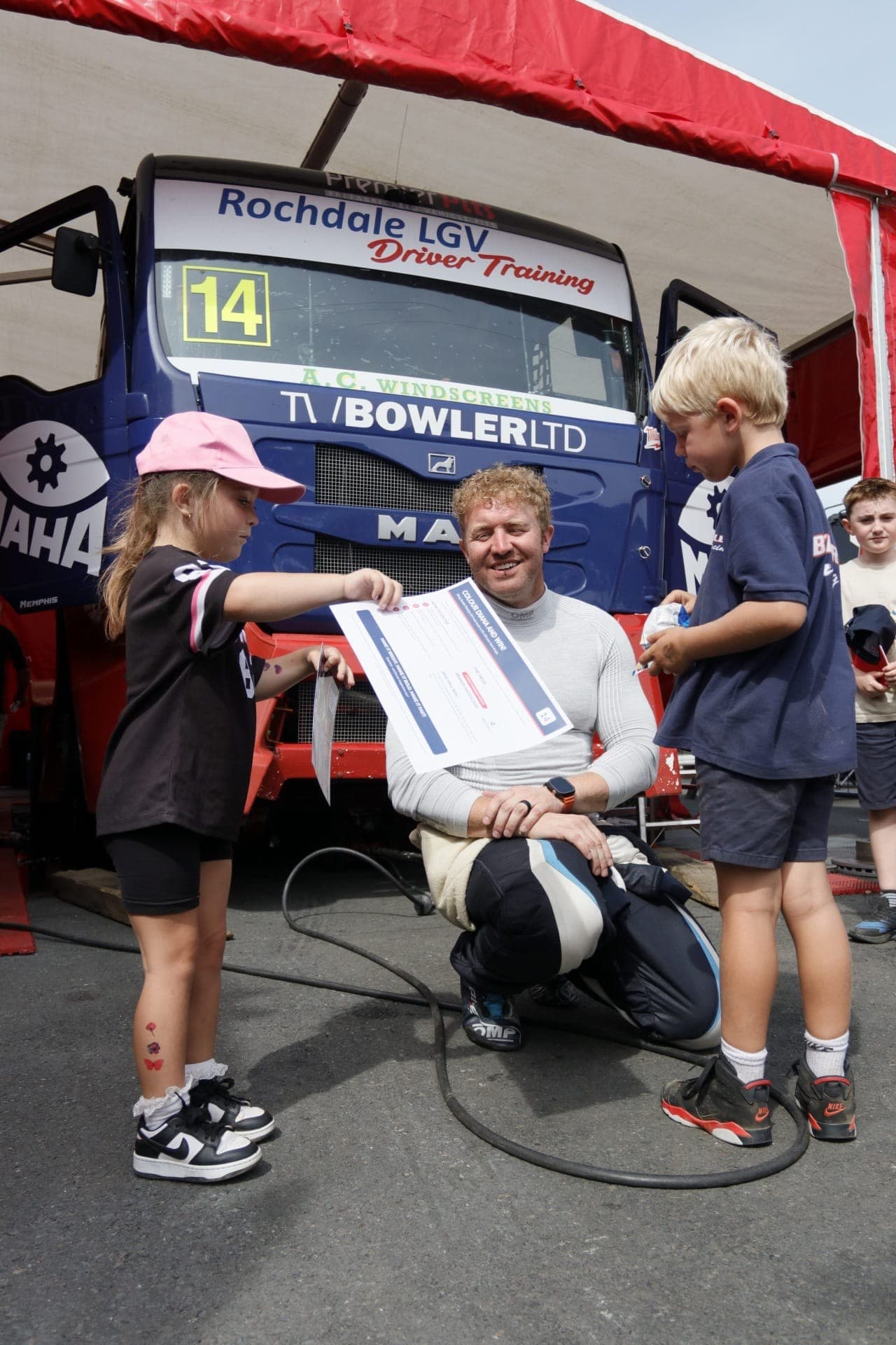 Young Bowler Racing fans showing John Bowler their Diana competition sheet